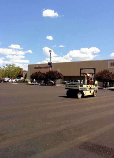 Roller compacting a new parking lot surface