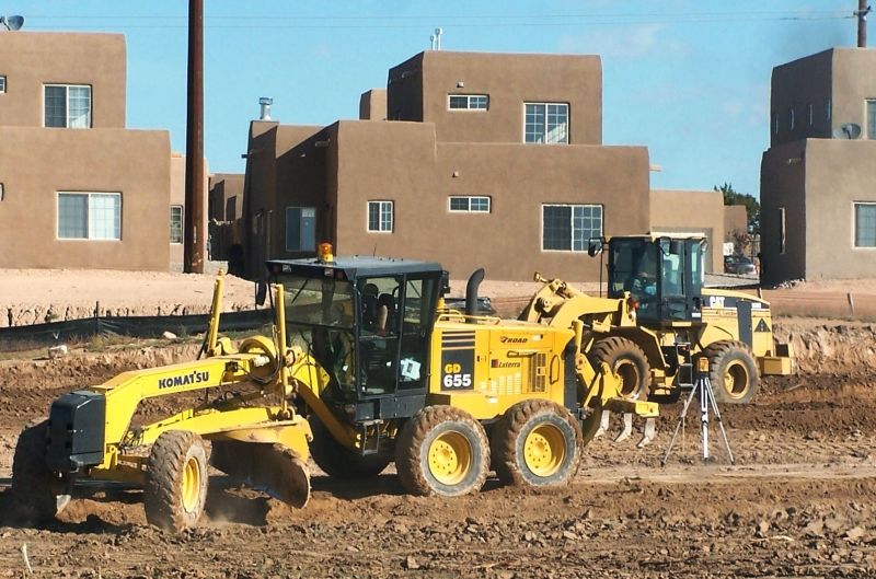 Grader and loader preparing a building pad