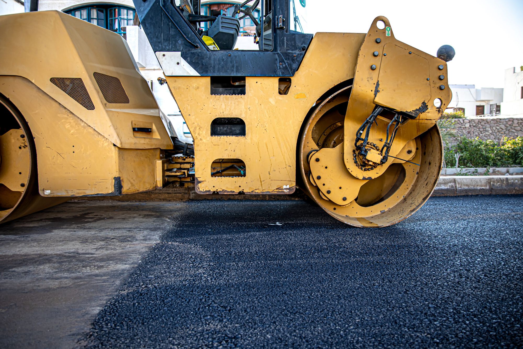 Road roller compacting fresh asphalt